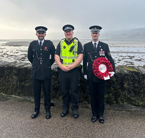 Three police officers in Lochgilphead holding poppy wreath