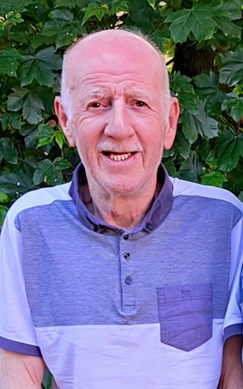 74-year-old man wearing blue top