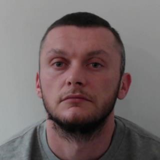 Image of man convicted Kurtis Taylor, round face with shaved dark hair and beard.