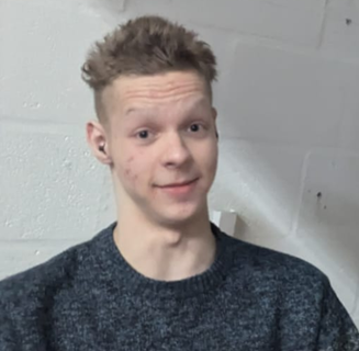 16-year-old white male with short brown hair. Wearing a black jumper