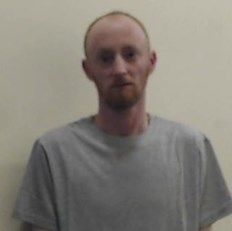 custody image of 36-year-old man wearing grey t-shirt