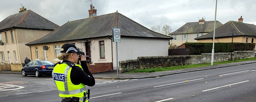 Female officer on road taking picture